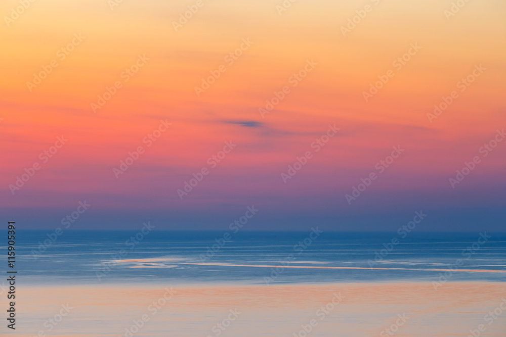 sunset over the mountain with reflection on the sea