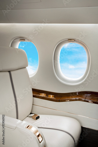 Clouds view in aircraft window, business jet flight