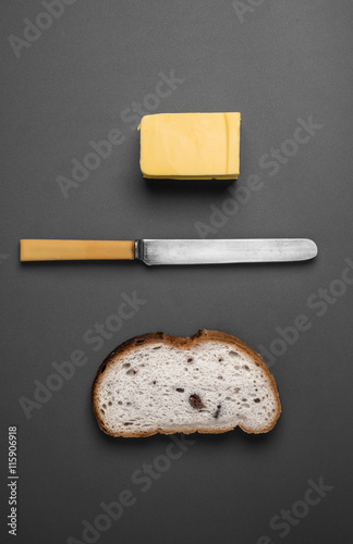 Bread and butter - knife, butter and bread viewed from above