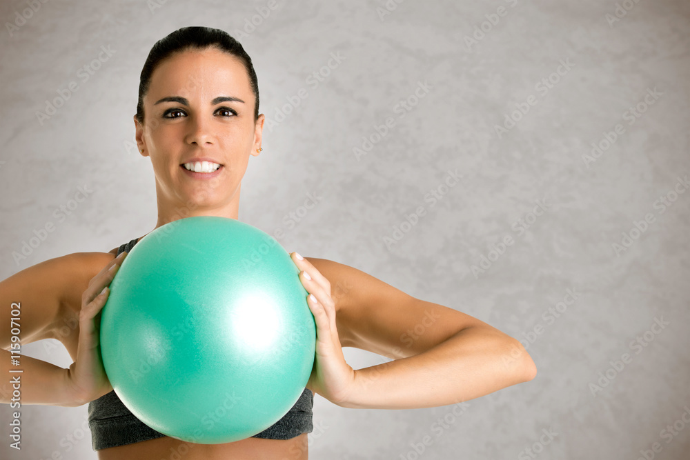Fit Woman Standing Holding a Pilates Ball Fit Woman Standing Holding a Pilates Ball