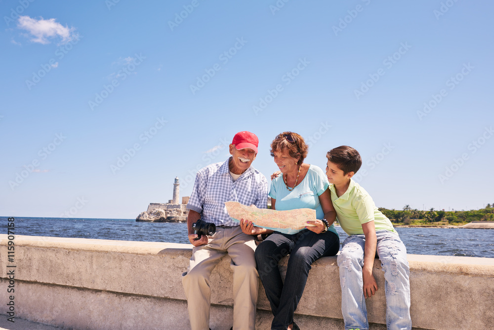 Family Grandparents Reading Tourist Map In Habana Cuba