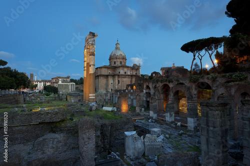 Exploring the ancient ruins at the Roman Forum in Rome, Italy after sunset 