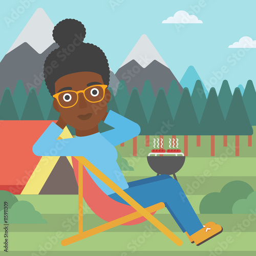 Woman sitting in folding chair in the camp.