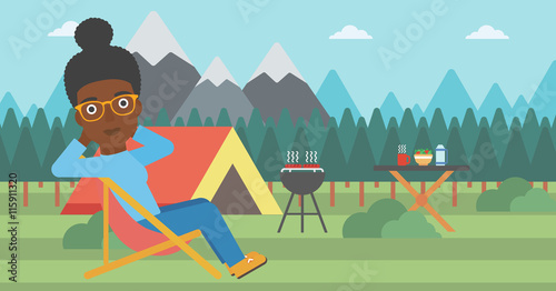 Woman sitting in folding chair in the camp.