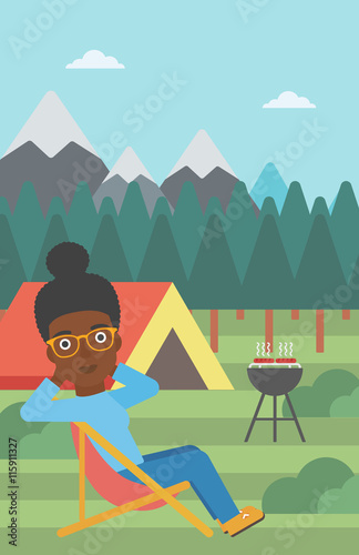 Woman sitting in folding chair in the camp.