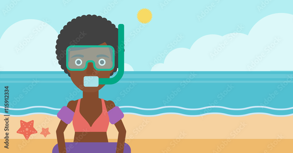 Woman with snorkeling equipment on the beach.