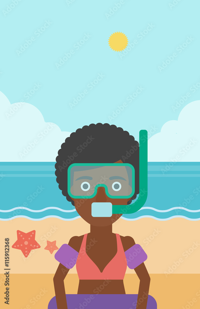 Woman with snorkeling equipment on the beach.