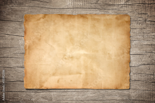 old brown paper on wood background for texture photo