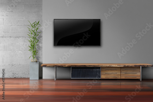 led tv on gray wall with wooden table in livg room