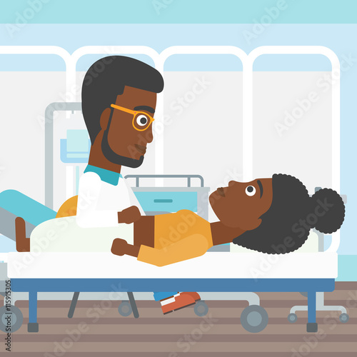 Doctor touching abdomen of female patient.