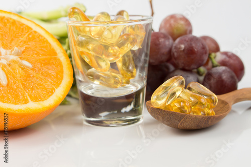 Fototapeta Naklejka Na Ścianę i Meble -  Vitamin Capsules with fruit on white