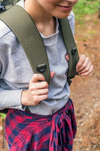 Close-up of female traveler with backpack in forest