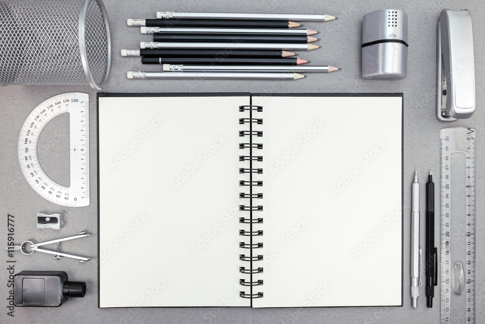 Fototapeta premium blank notebook and school supplies on recycled paper background