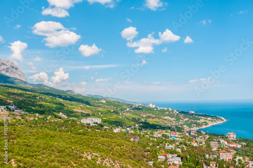 beach at the seaside, blue water, view from above the mountains to the town of Simeiz, Yalta, Crimea