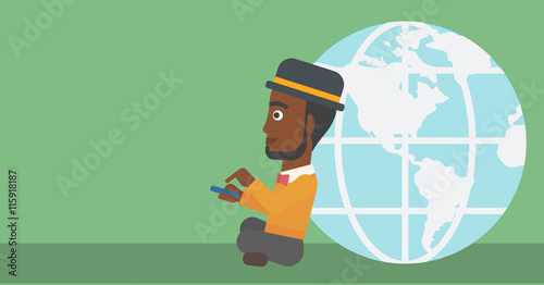 Businessman sitting near Earth globe.