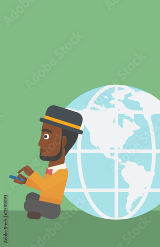Businessman sitting near Earth globe.
