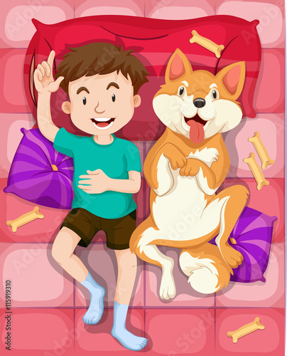 Boy and pet dog sleeping on bed