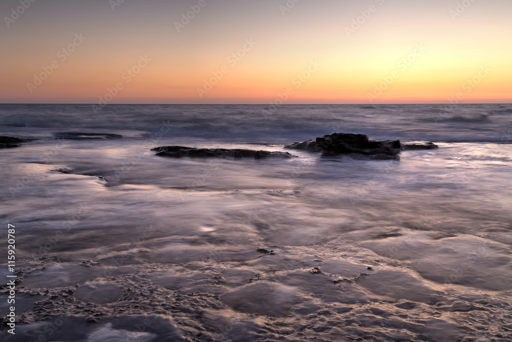 Naklejka premium Silky water on the rocks after sunset, Nahariya, HDR