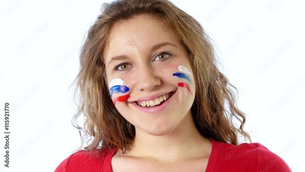Girl painting her face with Russian flag Girl painting her face with Russian flag
