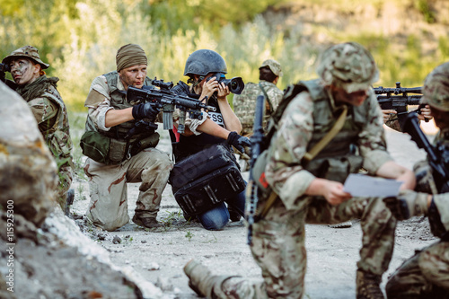 Bild auf Leinwand Photojournalist documenting war conflict. in the mountain.