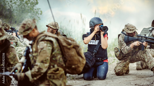 Photojournalist documenting war conflict. in the mountain. photo