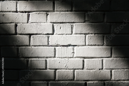 White brick wall with light spot