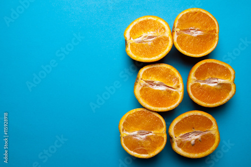 Cut oranges from above on blue background