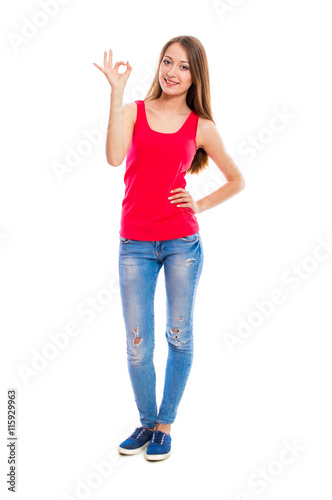Young attractive woman in blue jeans isolated on white background. Beautiful girl model posing in the studio.