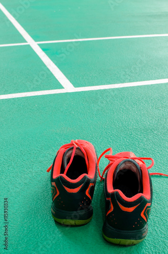 Top view of red sport shoes on green background