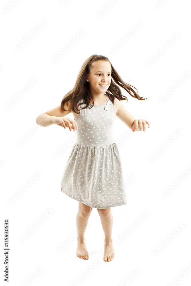 Adorable young girl dancing. Isolated on white background