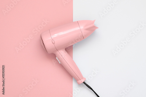 Schilderij op canvas Pink hair dryer on pink and white background