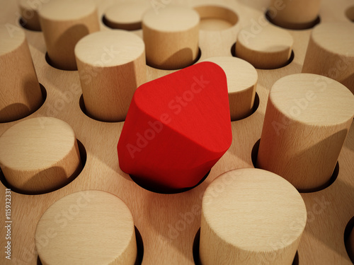 Red prism wooden block standing out among wooden cylinders. 3D illustration photo