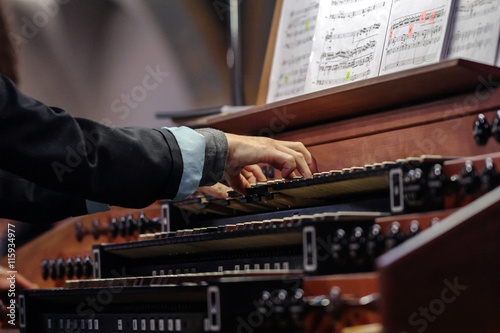 organist playing a pipe organ photo