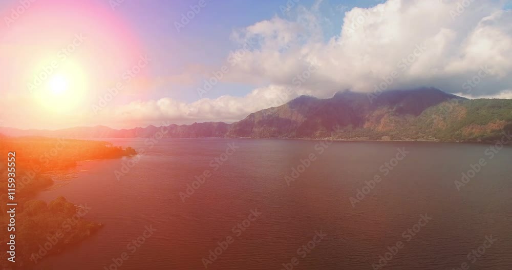 Aerial view, flight above lake. Sunrise in the mountains, Bali nature in the morning, morning sunrise on Batur volcano, sunrise view to lake and mountain, landscape Aerial view, flight above lake. Sunrise in the mountains, Bali nature in the morning, morning sunrise on Batur volcano, sunrise view to lake and mountain, landscape