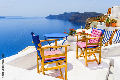 Fototapeta Naklejka Na Ścianę i Meble -  Two chairs with table on a terrace in Santorini, Greece