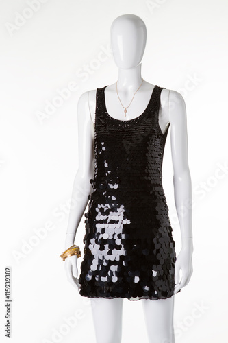 Shiny black dress with sequins on a white mannequin. photo