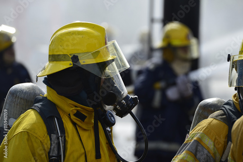 Fireman in action while wearing a fire suit.