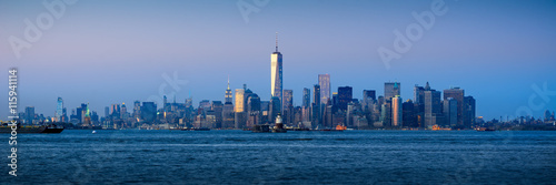 Panoramic Lower Manhattan Financial District skyscrapers and New York City Harbor at twilight