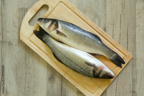 Whole seabass on a wooden board