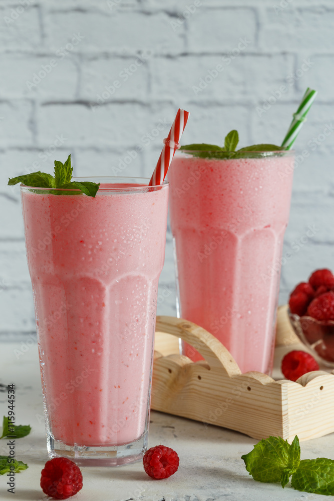 Raspberry milkshake with mint and straws. Raspberry milkshake with mint and straws.