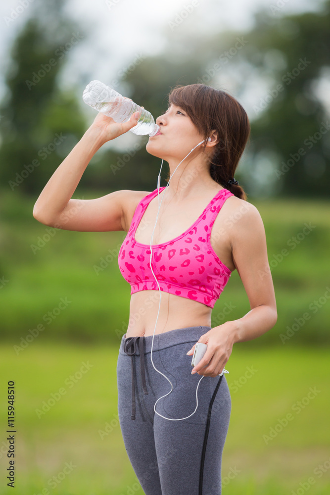 Girl drinking water while exercising with thirst. Girl drinking water while exercising with thirst.