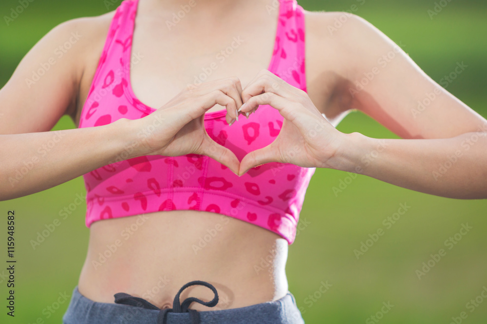 Beautiful young woman over doing a heart shape with her hands Beautiful young woman over doing a heart shape with her hands