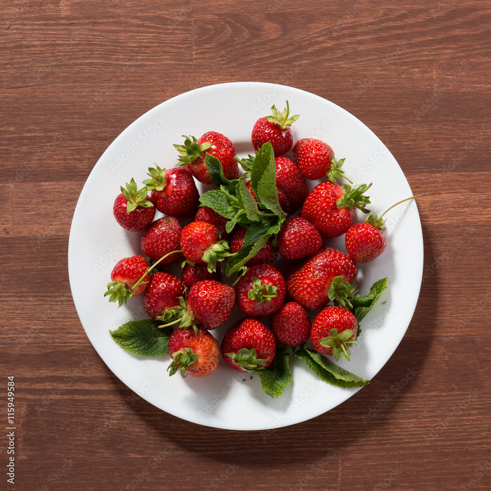 Ripe red strawberries on wooden table. Strawberry. Fresh strawberry. Red strewberry. Strawberry Juice. Loosely laid strawberries in different positions. Ripe red strawberries on wooden table. Strawberry. Fresh strawberry. Red strewberry. Strawberry Juice. Loosely laid strawberries in different positions.
