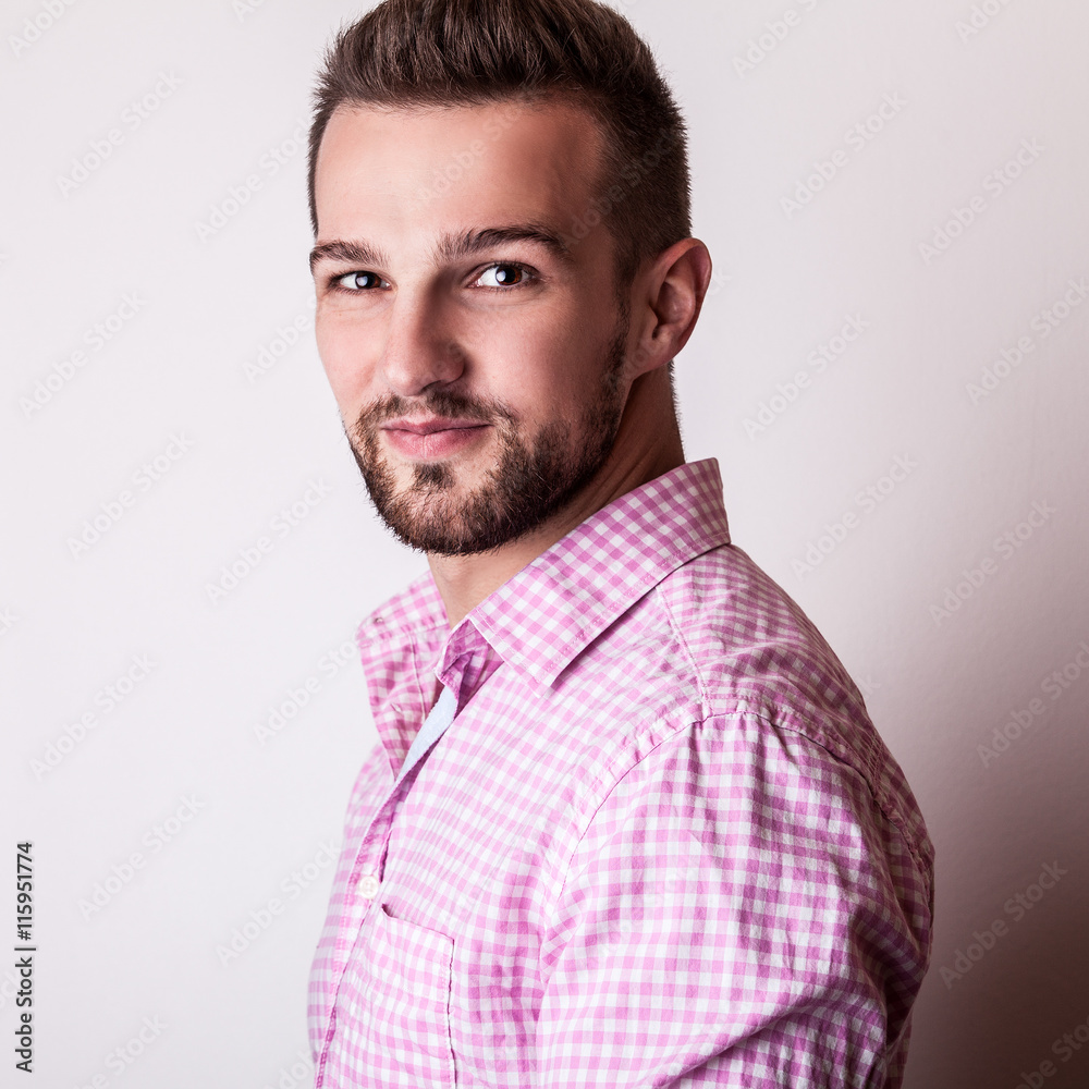 Obraz premium Young handsome man in colorful shirt pose in studio.