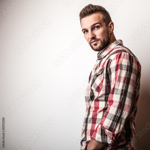 Fotografía Young handsome man in colorful shirt pose in studio.