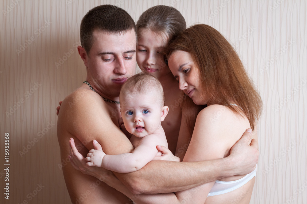 Family father, mother and two daughters indoors Family father, mother and two daughters indoors