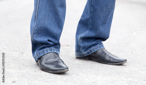 male legs in jeans and shoes