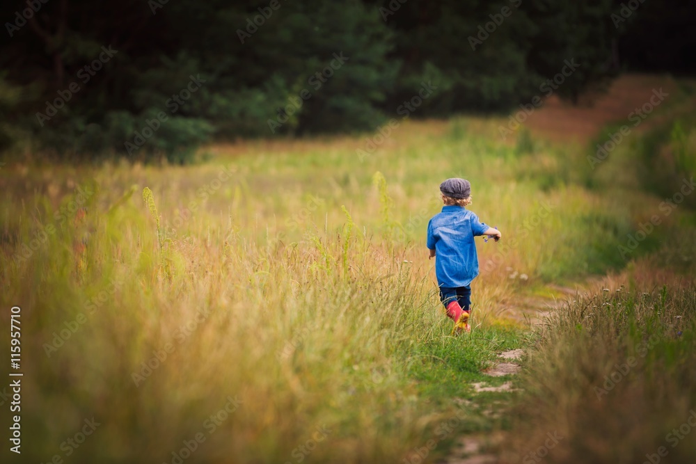 Young boy playing on fields in countryside