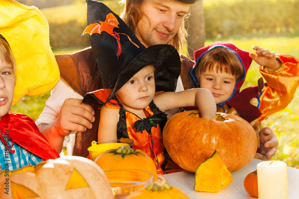 Fototapeta premium Cute kids and father in Halloween costumes