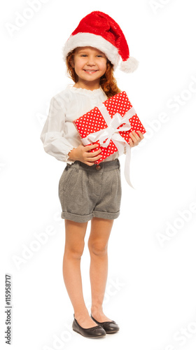 Portrait of girl with big present and Santa hat